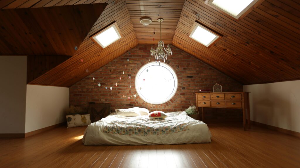 pexels-photo-271743-271743 A warm and inviting attic bedroom featuring a unique brick wall and wooden ceiling design.