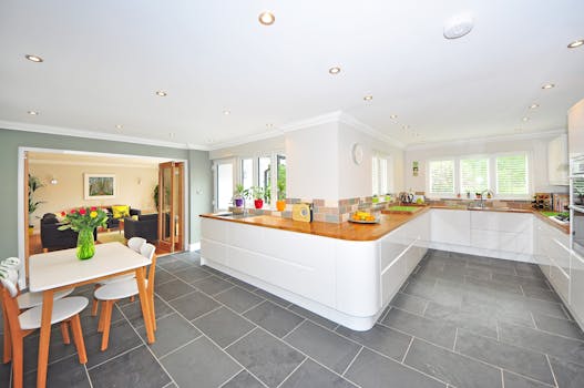 pexels-photo-280232-280232 A spacious modern kitchen with elegant interiors featuring a dining table and luxurious design.