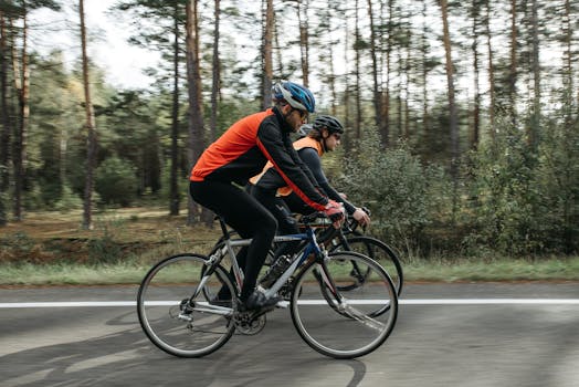 Two cyclists riding through a scenic forest, enjoying a leisure bike ride.